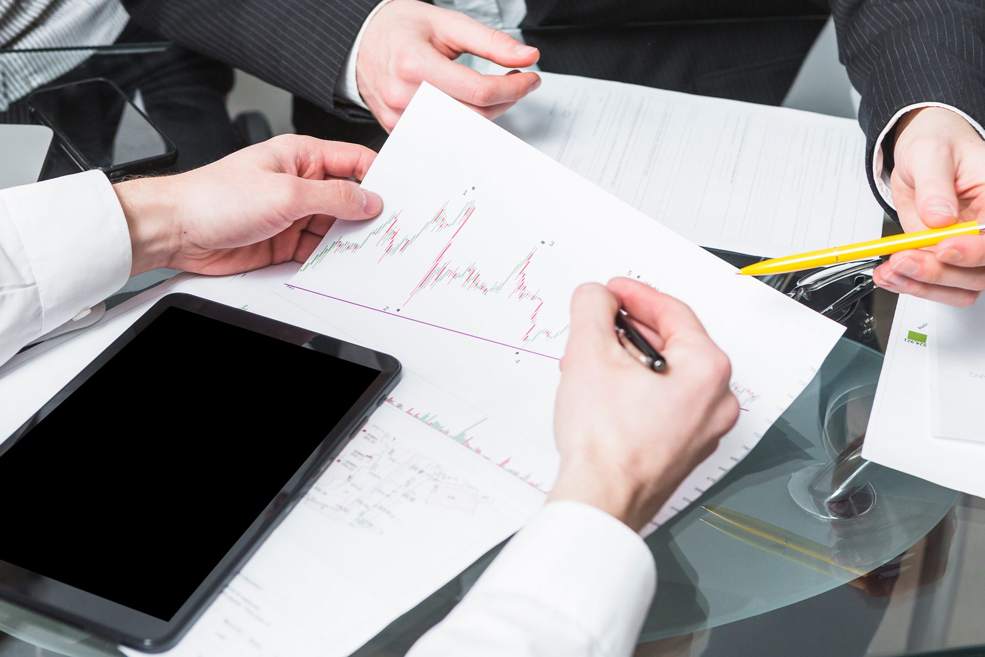 A Person Writing on a Paper with Graph<br />